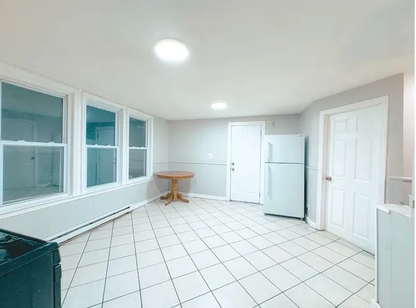 a view of a room with a lounge chair and windows