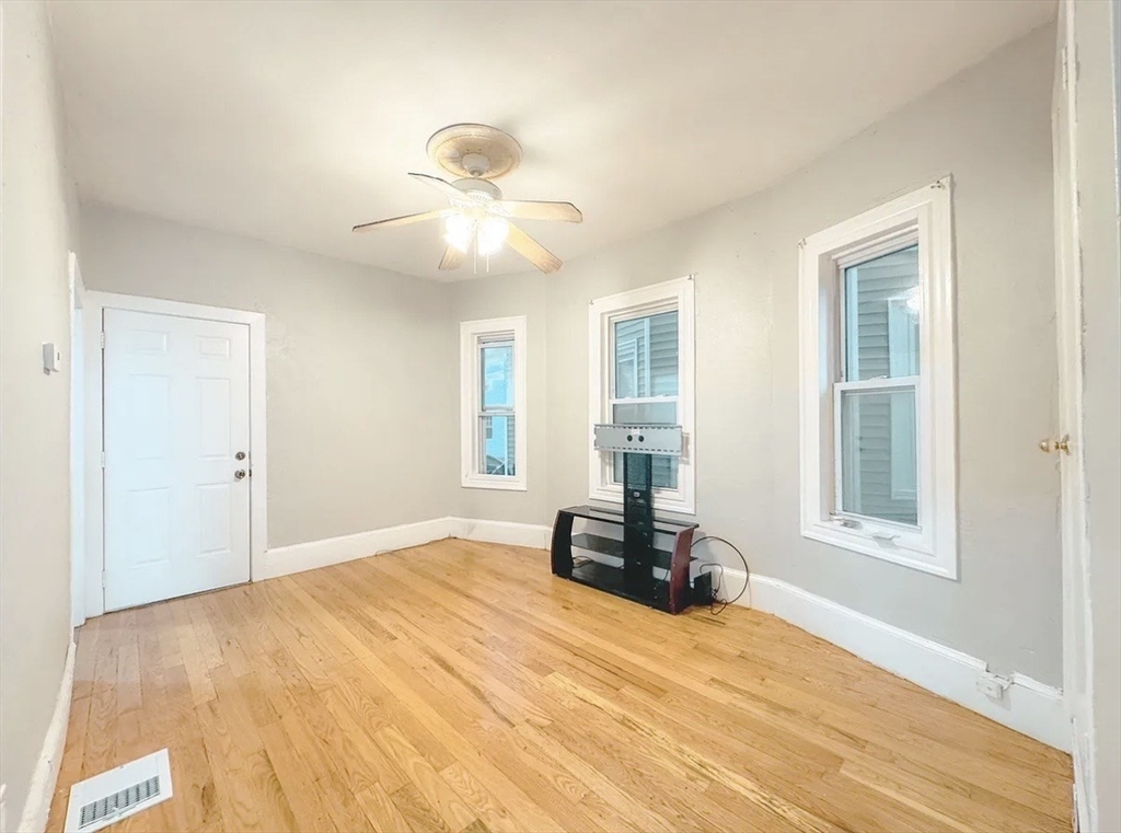 37 Maverick Street Chelsea, MA 02150 - Photo 21 of 25 a bed room with a bed and a window