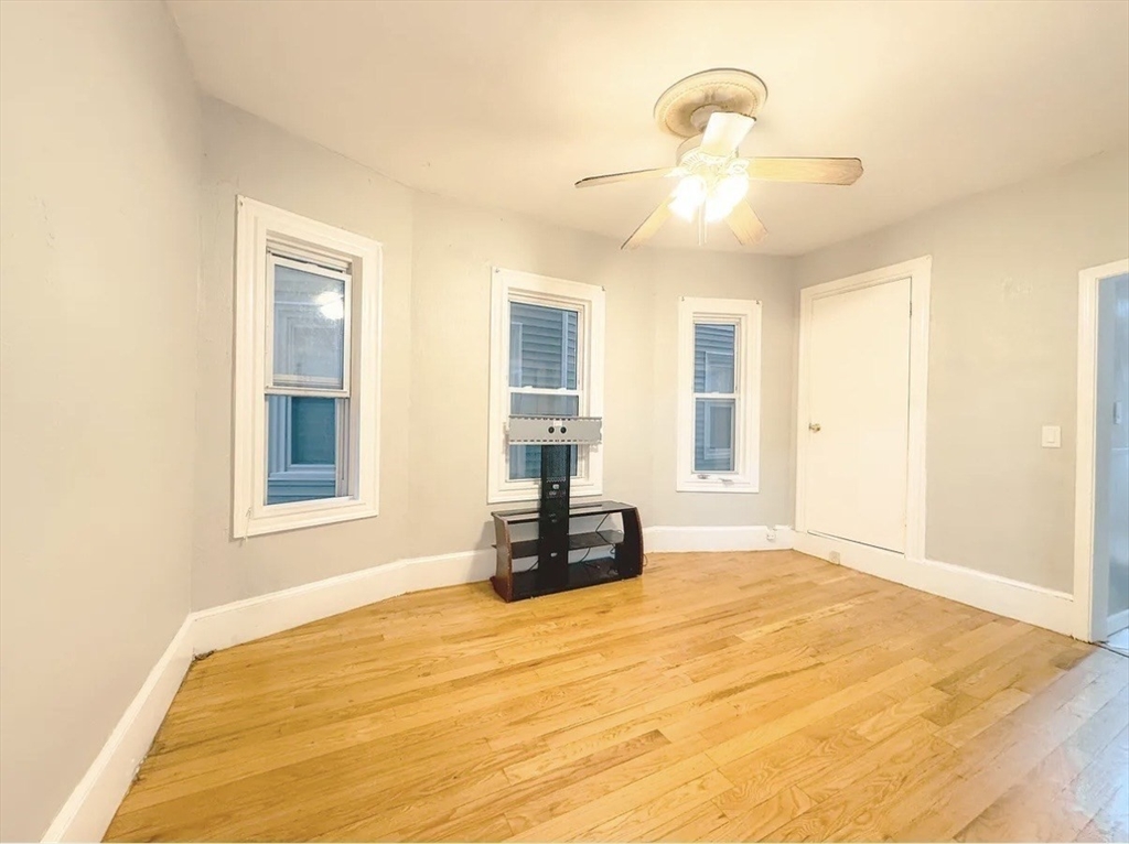 37 Maverick Street Chelsea, MA 02150 - Photo 22 of 25 a bedroom with a bed and wooden floor