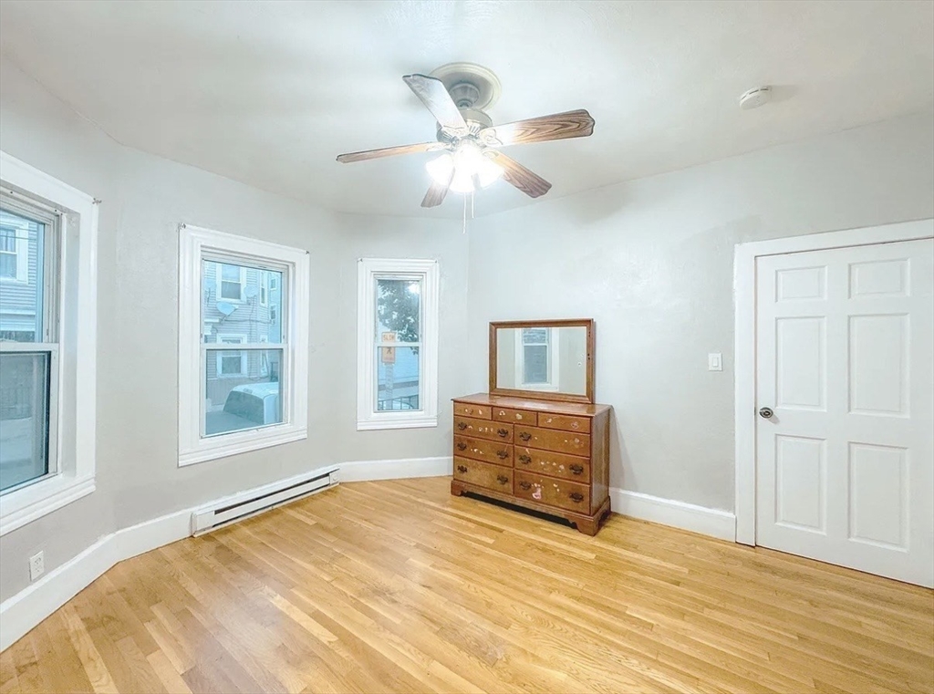 37 Maverick Street Chelsea, MA 02150 - Photo 23 of 25 a bedroom with a bed and a window