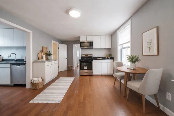 a kitchen with white cabinets and stainless steel appliances