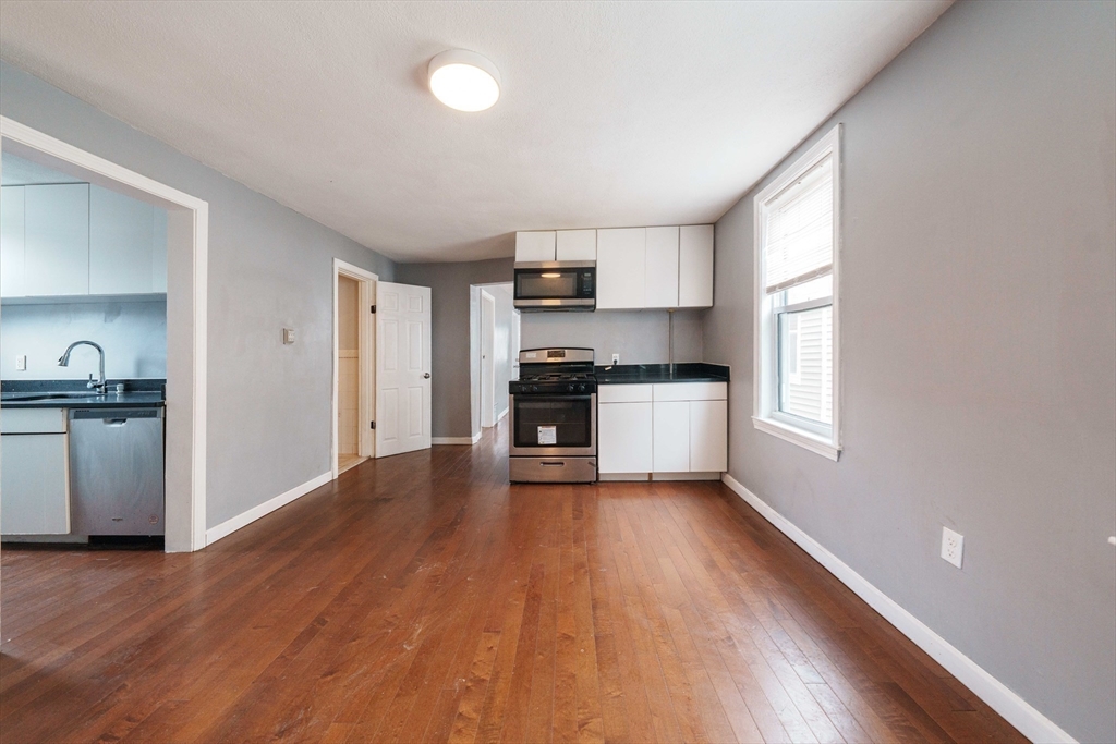 37 Maverick Street Chelsea, MA 02150 - Photo 6 of 25 a kitchen with wooden floors and white appliances