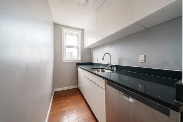 a kitchen with a sink and a window