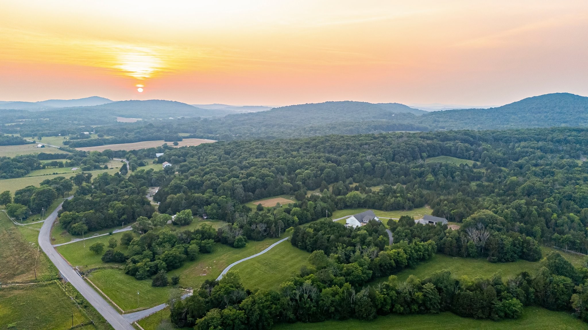 2825 Oregon Road Milton, TN 37118 - Photo 3 of 71 an aerial view of green landscape with trees houses and mountain view