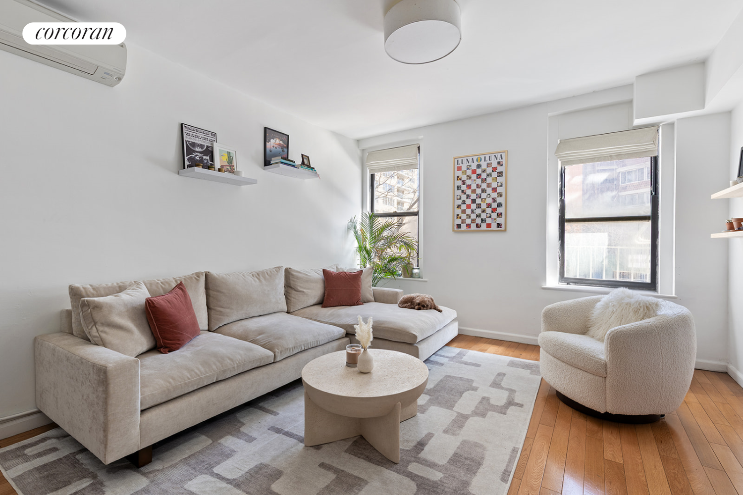 a living room with furniture and a wooden floor
