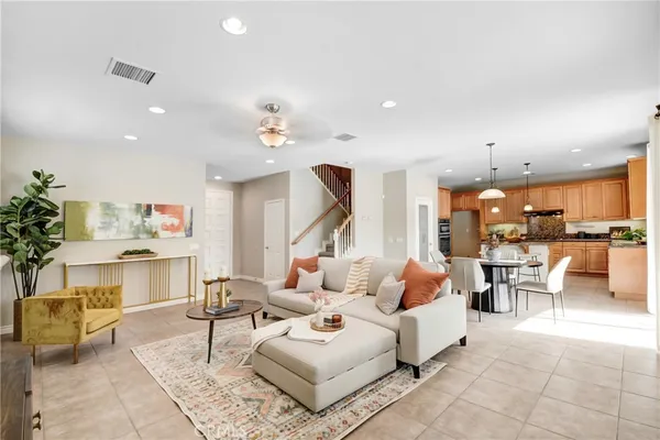 a living room with furniture and a kitchen view