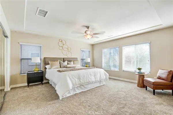 a bedroom with a bed and a couch