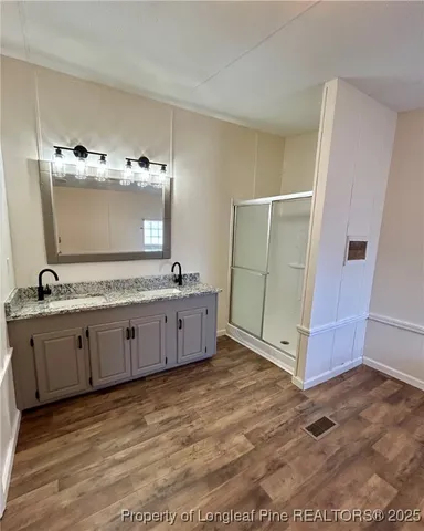 a bathroom with a double vanity sink and mirror