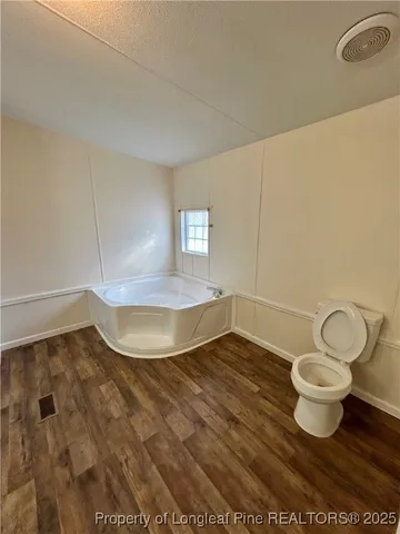 a view of a room with wooden floor and chair