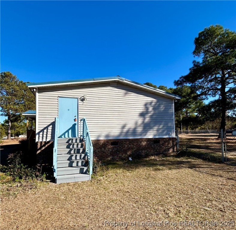 193 Clarington Court Lumber Bridge, NC 28357 - Photo 22 of 25 a front view of a house with a yard