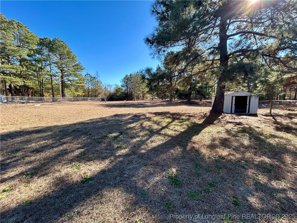 193 Clarington Court Lumber Bridge, NC 28357 - Photo 23 of 25 a view of a yard with wooden fence