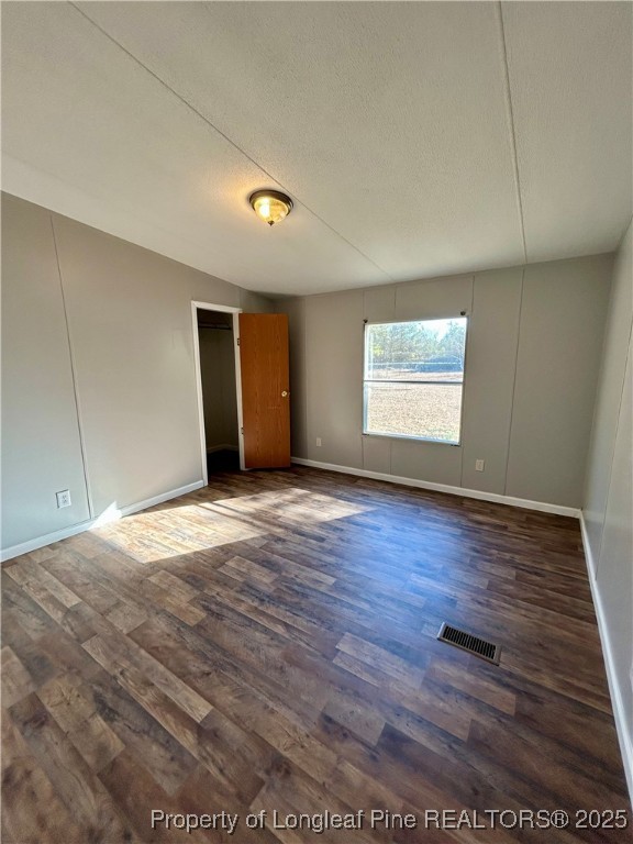 193 Clarington Court Lumber Bridge, NC 28357 - Photo 5 of 25 an empty room with wooden floor and windows