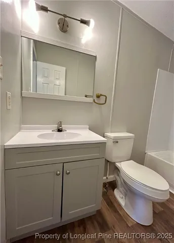 a bathroom with a sink toilet and mirror