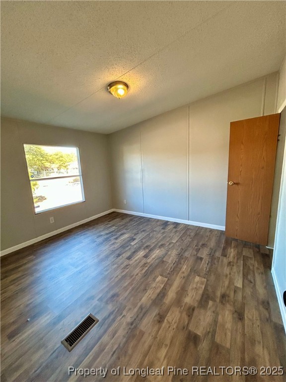 193 Clarington Court Lumber Bridge, NC 28357 - Photo 9 of 25 an empty room with wooden floor and windows