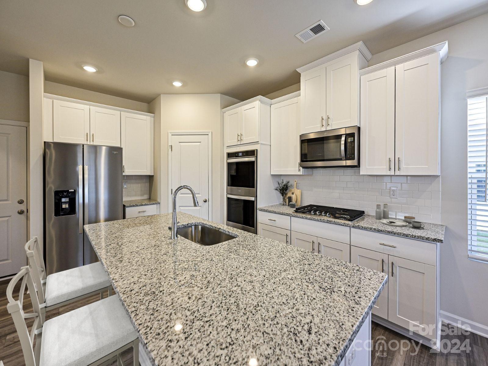 613 Windage Way Pineville, NC 28134 - Photo 3 of 10 a kitchen with stainless steel appliances granite countertop a refrigerator and a stove top oven