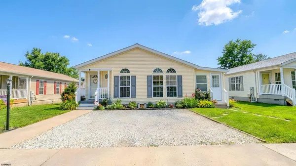 a front view of a house with a yard and porch