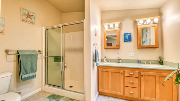 a bathroom with a granite countertop sink mirror and double