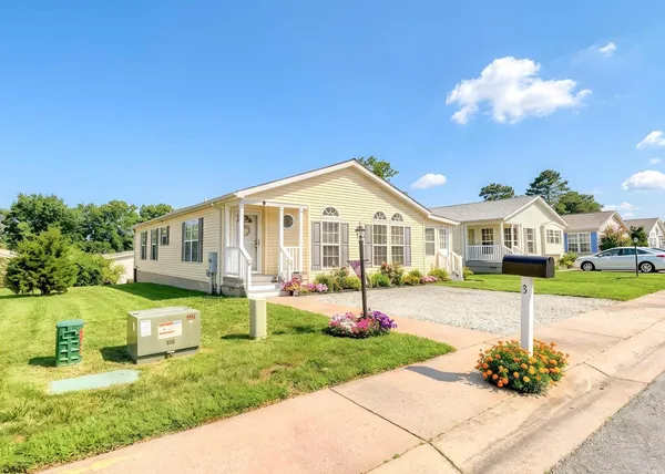 a front view of a house with a yard and porch