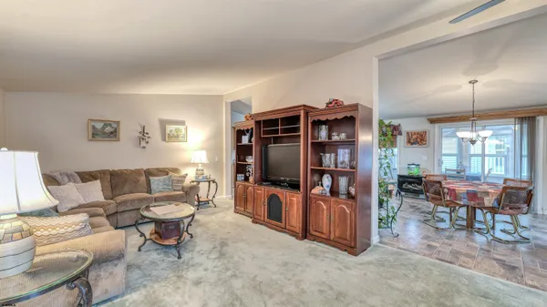 a living room with furniture a window and a flat screen tv