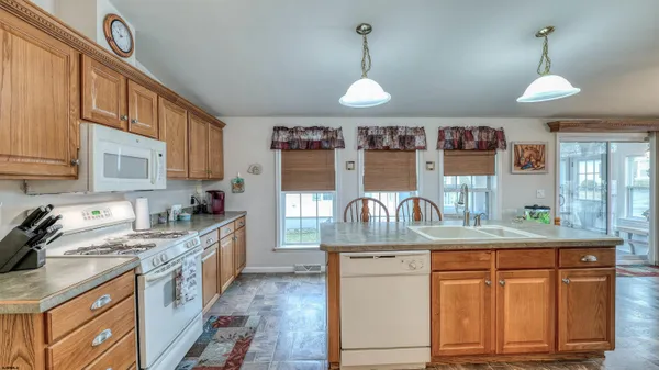 a kitchen with granite countertop a sink cabinets and window