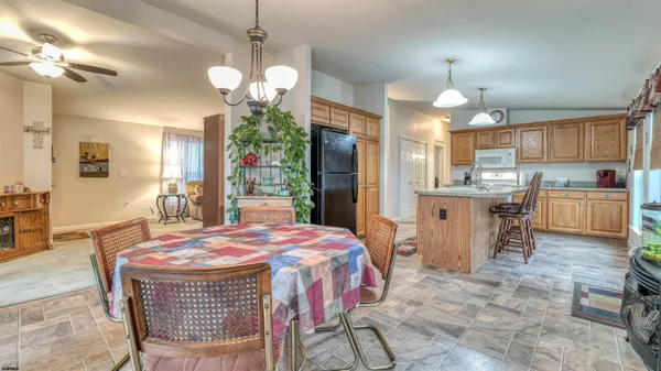 a dining room with granite countertop a table chairs and chandelier