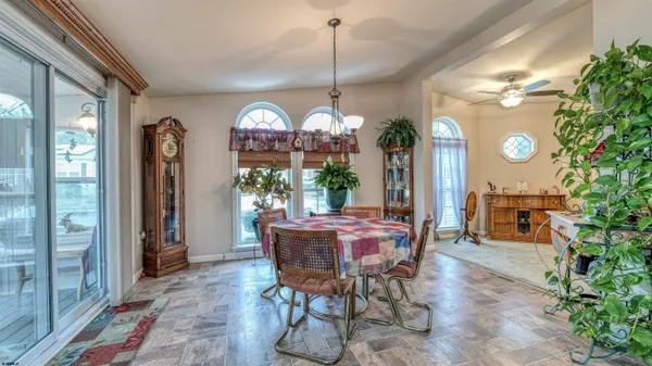 a dining room with furniture and window
