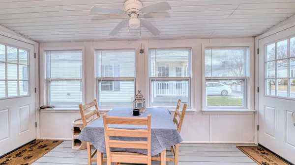 a view of a dining room with furniture wooden floor and windows