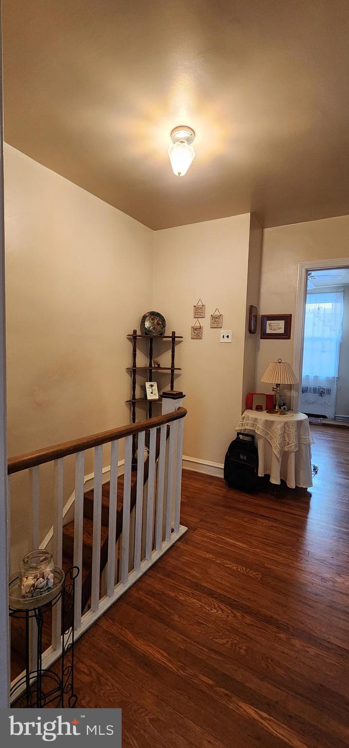 5624 Arbor Street Philadelphia, PA 19120 - Photo 12 of 17 a view of a hallway with wooden floor