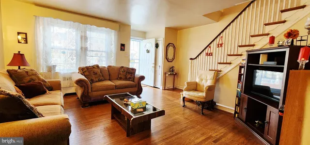 a living room with furniture fireplace and a window