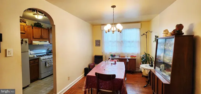 a dining room with furniture and a chandelier