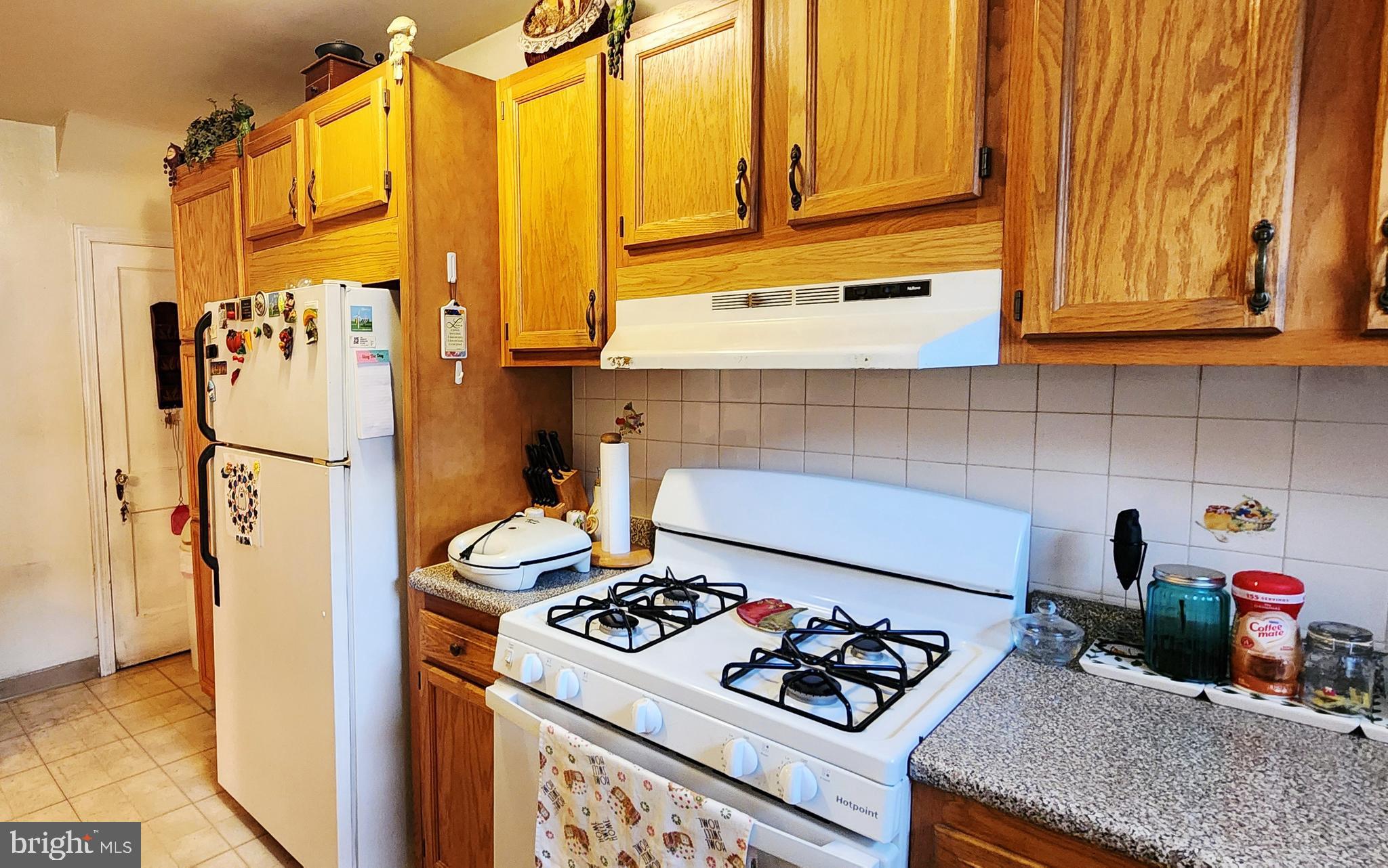 5624 Arbor Street Philadelphia, PA 19120 - Photo 9 of 17 a kitchen with stainless steel appliances granite countertop a refrigerator and a stove