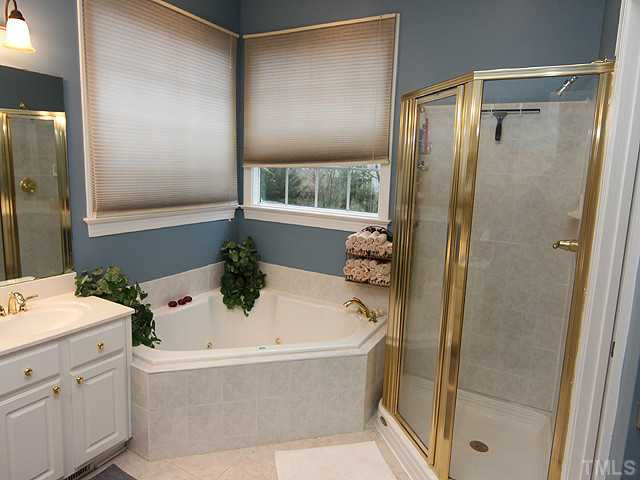 3805 Evander Way Raleigh, NC 27613 - Photo 12 of 23 The master bath features a jetted tub, separate walk-in shower and tiled floors Master Bath/Spa