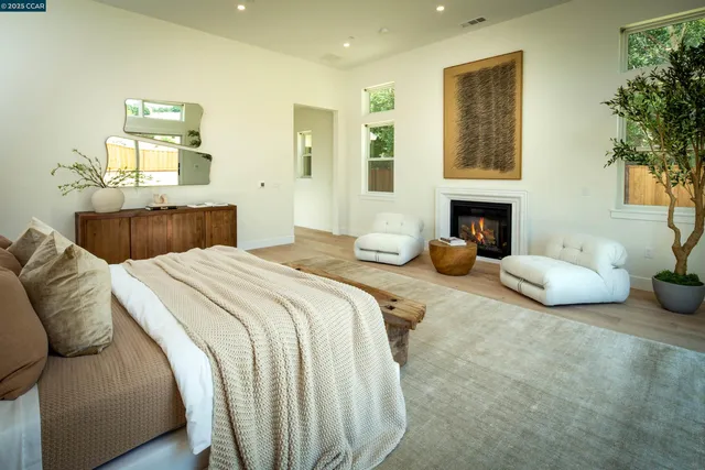 a spacious bedroom with a bed and a fireplace