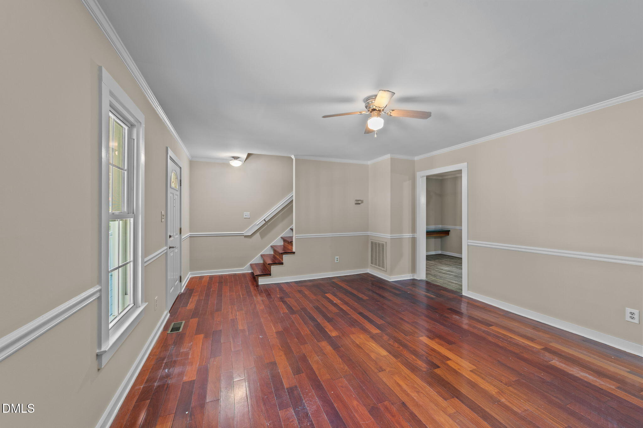 804 Olive Street Apex, NC 27502 - Photo 20 of 40 a view of empty room with wooden floor and fan