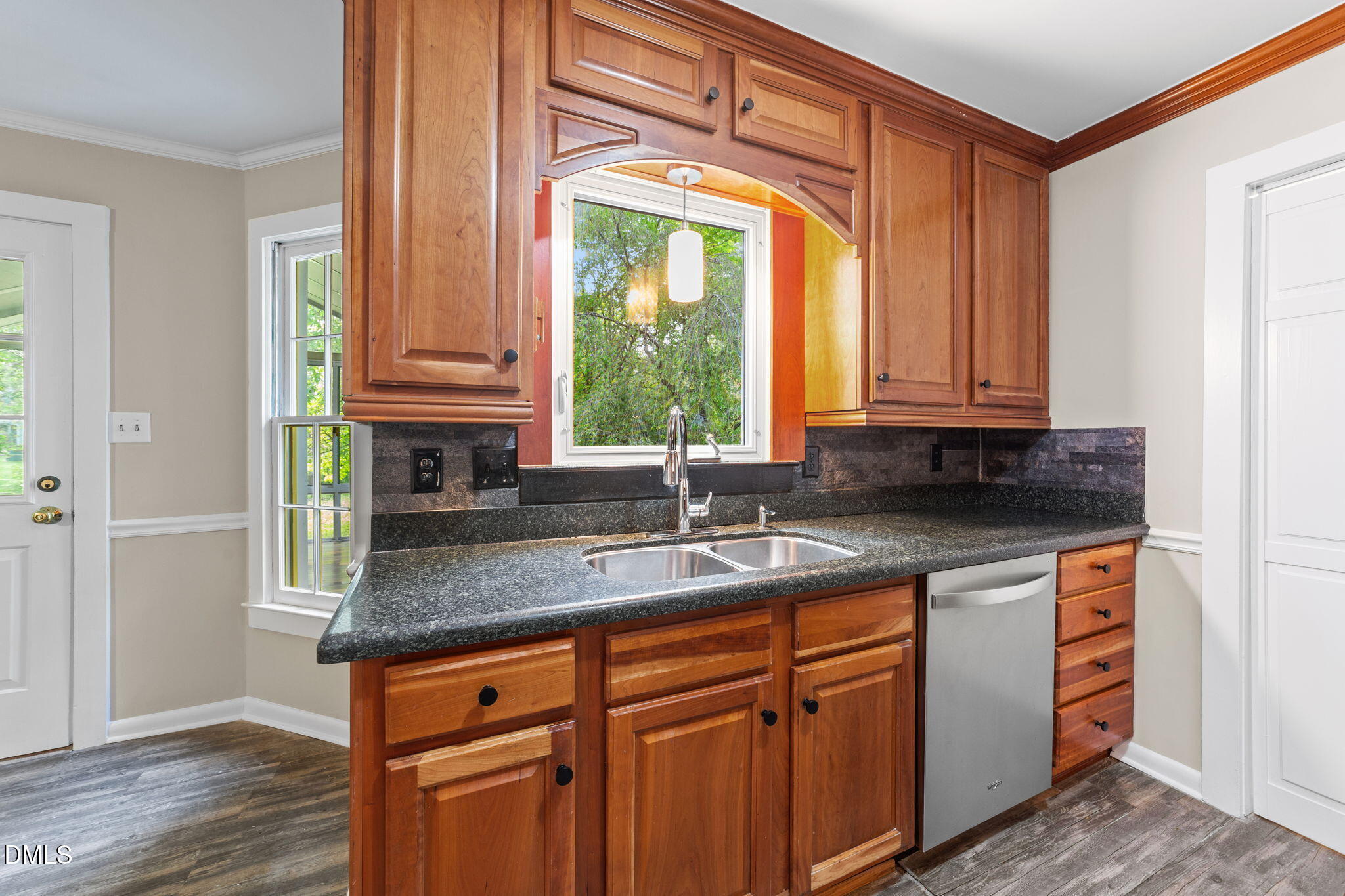 804 Olive Street Apex, NC 27502 - Photo 27 of 40 a kitchen with stainless steel appliances granite countertop a sink and a window