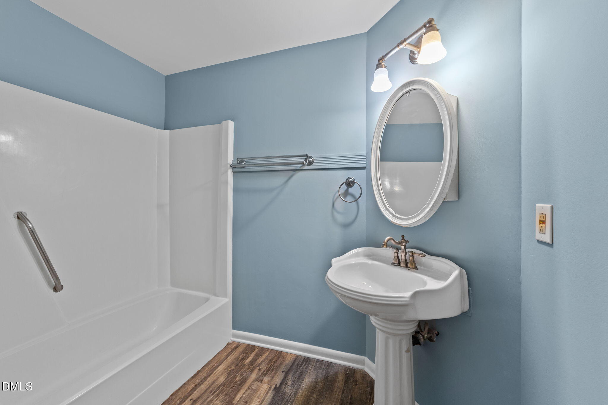 804 Olive Street Apex, NC 27502 - Photo 32 of 40 a bathroom with a sink toilet and a mirror