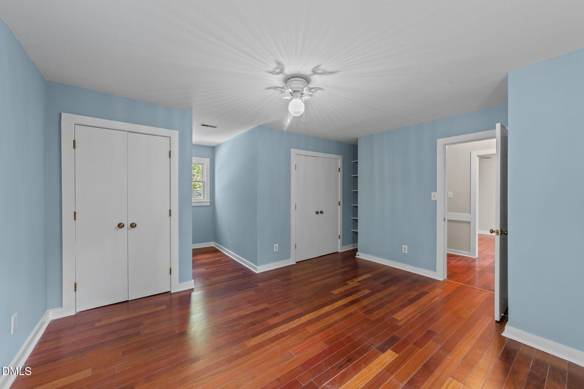 804 Olive Street Apex, NC 27502 - Photo 37 of 40 a view of an empty room with wooden floor