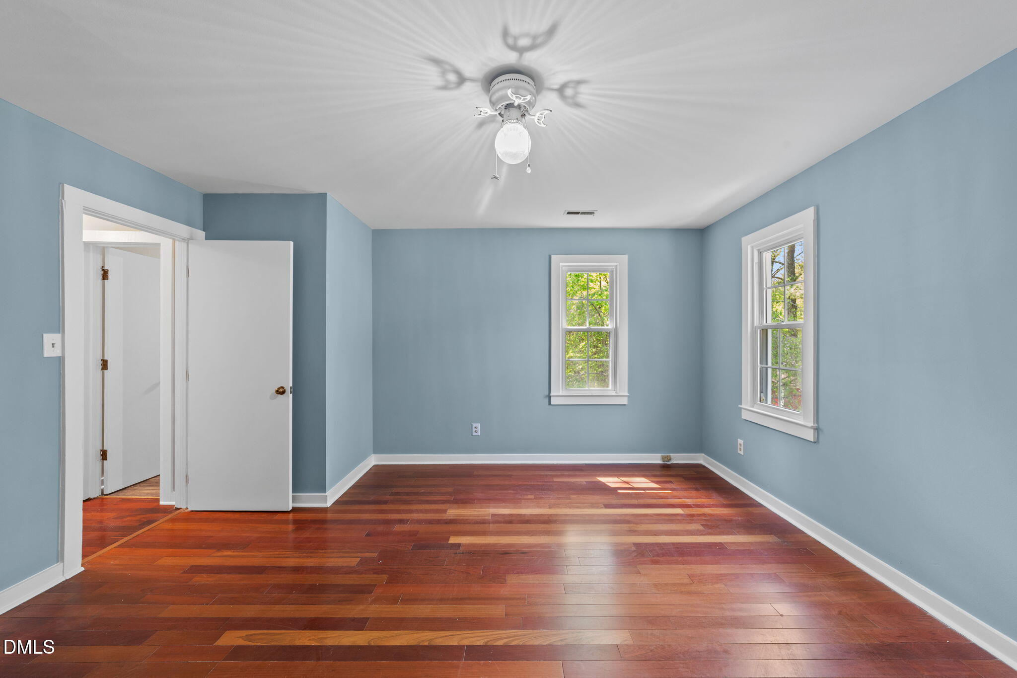 804 Olive Street Apex, NC 27502 - Photo 38 of 40 a view of an empty room with window and wooden floor