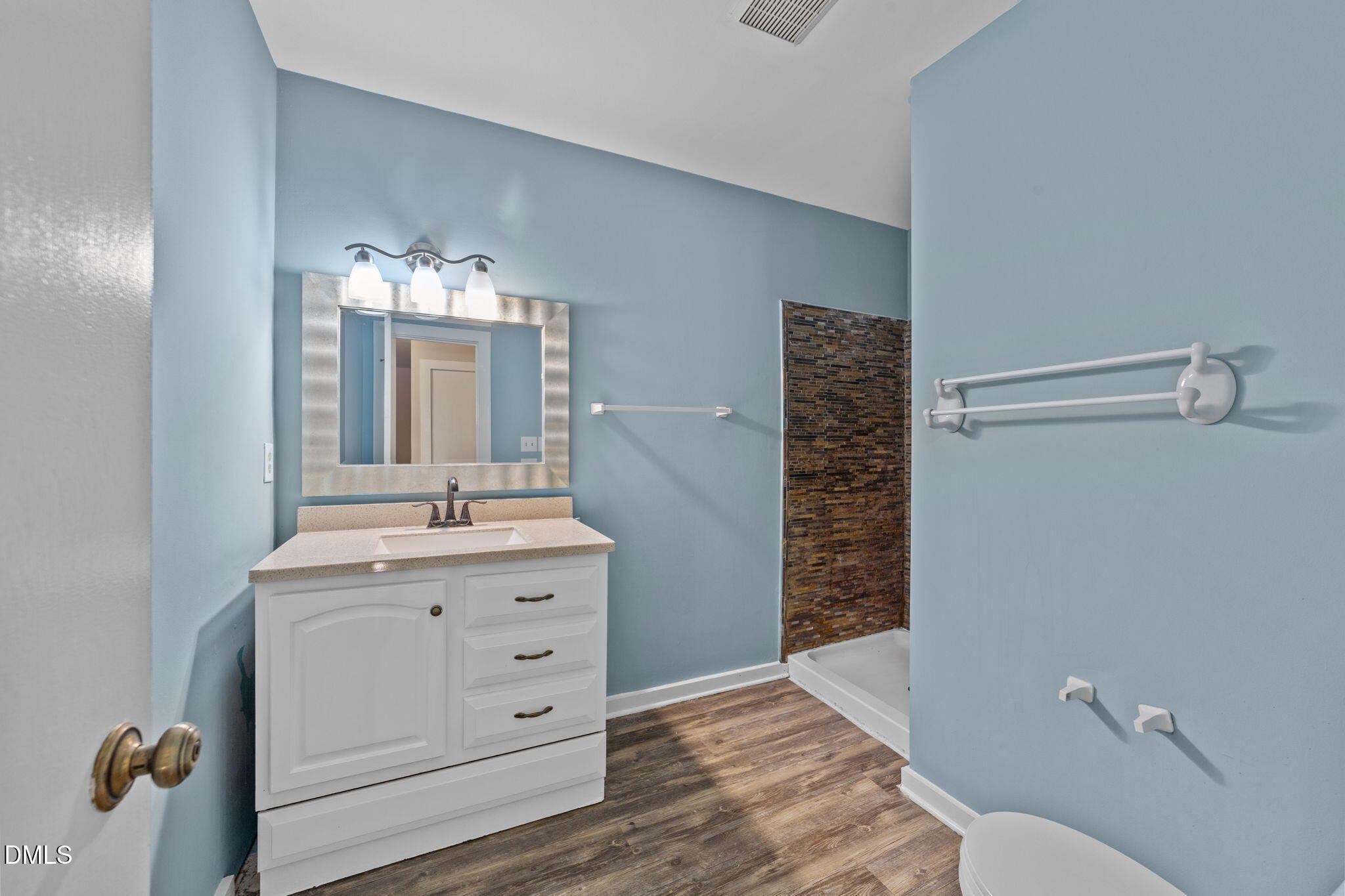 804 Olive Street Apex, NC 27502 - Photo 39 of 40 a bathroom with a sink a toilet and shower