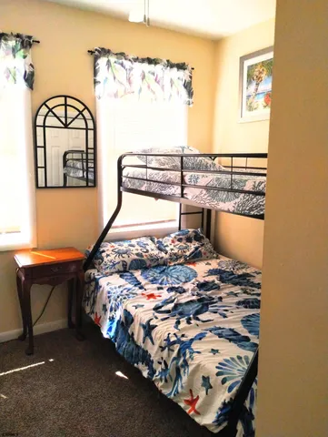 a bed sitting in a bedroom next to a window