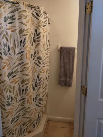 a bathroom with a shower and a curtain