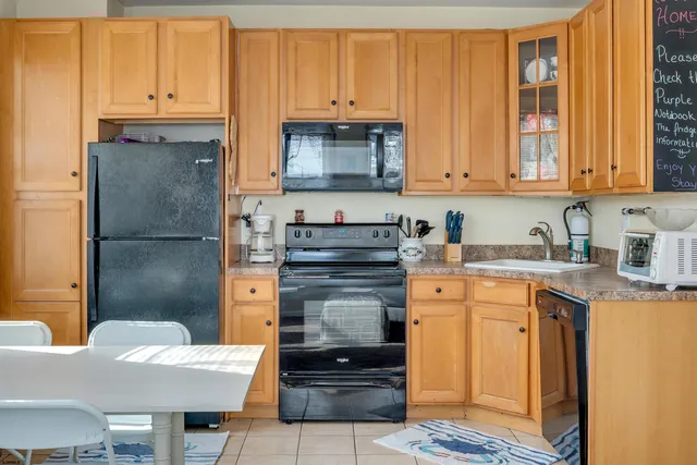 a kitchen with stainless steel appliances granite countertop a refrigerator sink and cabinets
