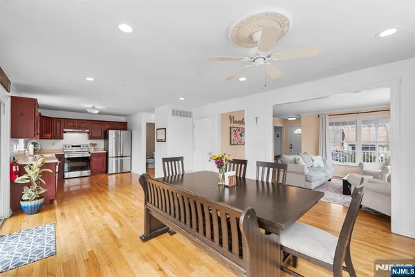 a view of a dining room with furniture window and wooden floor