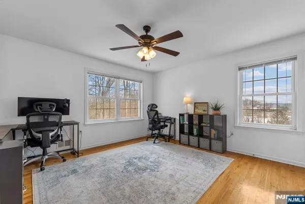 a view of a workspace with furniture and a ceiling fan