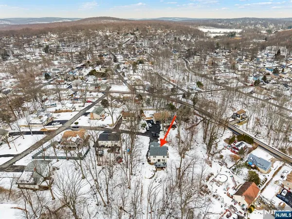 a view of a yard with snow on the road