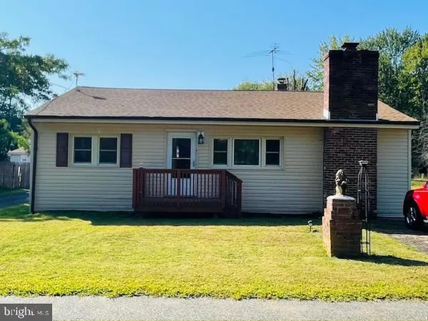 a view of a house with a wooden fence