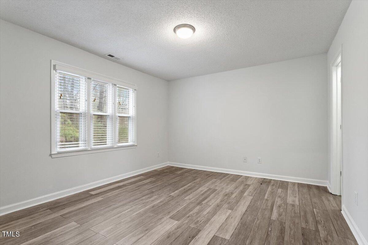 3307 Tarleton West, Unit A4 Durham, NC 27713 - Photo 13 of 40 an empty room with wooden floor and windows