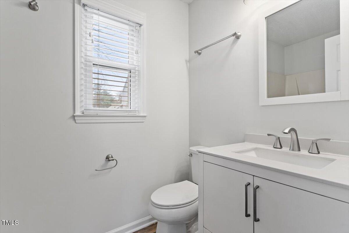 3307 Tarleton West, Unit A4 Durham, NC 27713 - Photo 16 of 40 a bathroom with a toilet sink and mirror