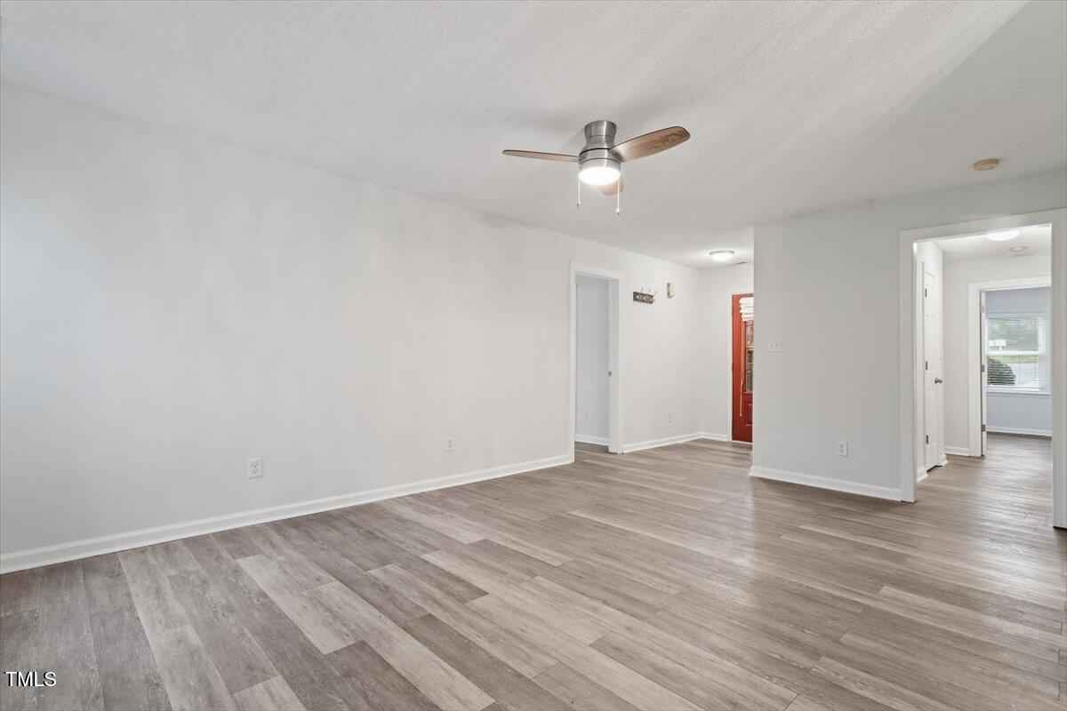 3307 Tarleton West, Unit A4 Durham, NC 27713 - Photo 19 of 40 an empty room with wooden floor and windows