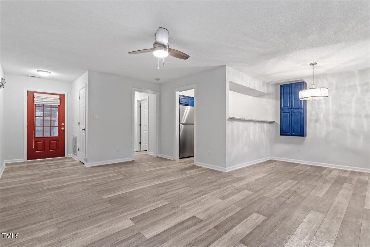 3307 Tarleton West, Unit A4 Durham, NC 27713 - Photo 20 of 40 a view of an empty room with window and wooden floor